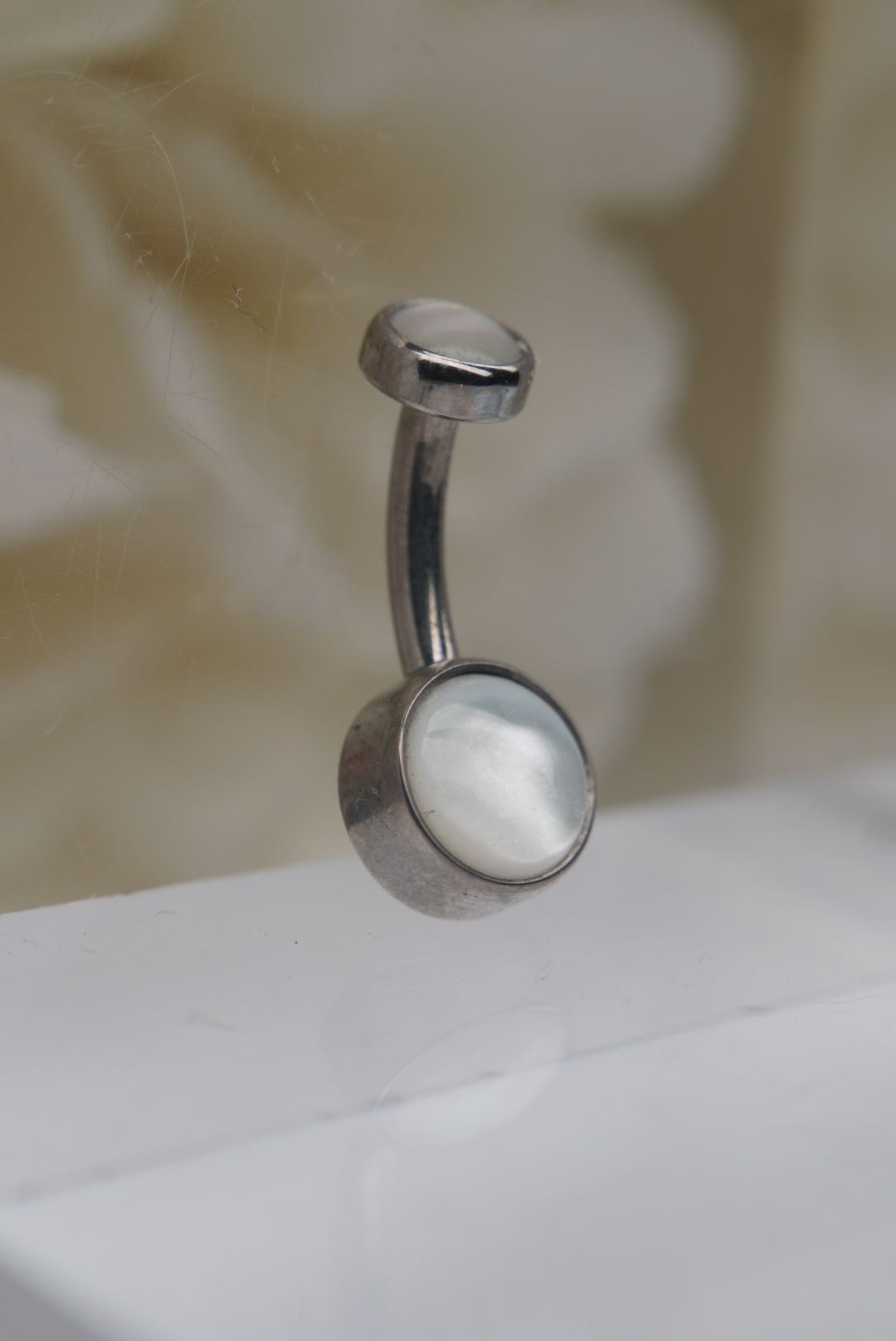 White Mother of Pearl Navel in a Bezel Setting (4mm/6mm) angled view