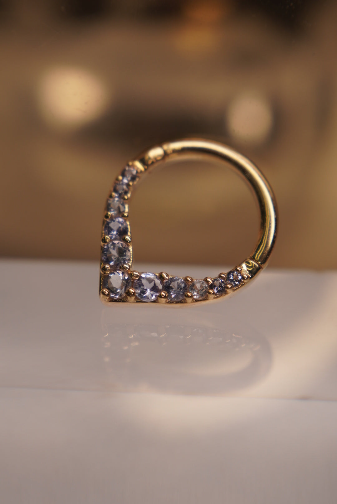 Angled view showing the pointed shape and gemstone settings.