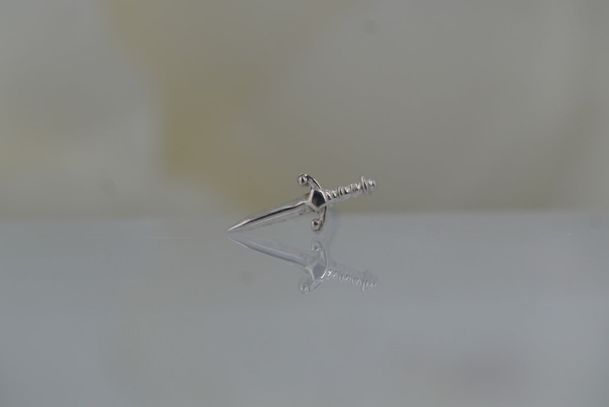 Front view of Buddha Jewelry’s “Blade” in 14k white gold, featuring a sleek, elongated sword silhouette with a polished finish.