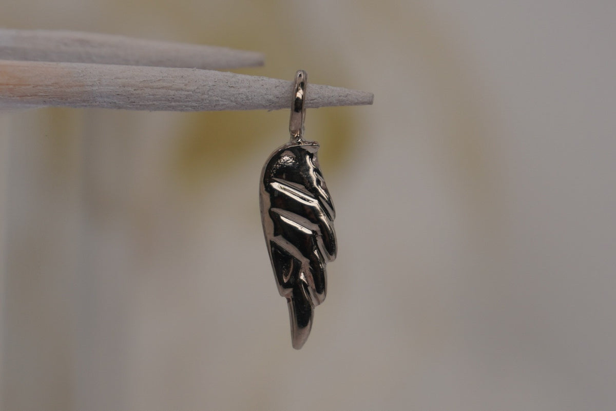 Side Facing Norvoch 14k Angel Wing Charm pendant in white gold piercing charm, side view