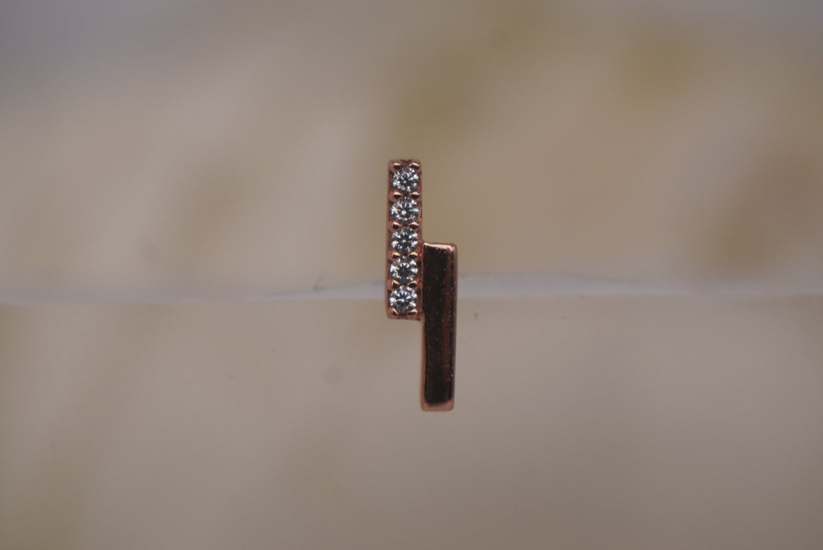 Front view of Buddha Jewelry’s “Encore” in 14k rose gold, featuring a slim polished bar paired with a line of shimmering crystals.