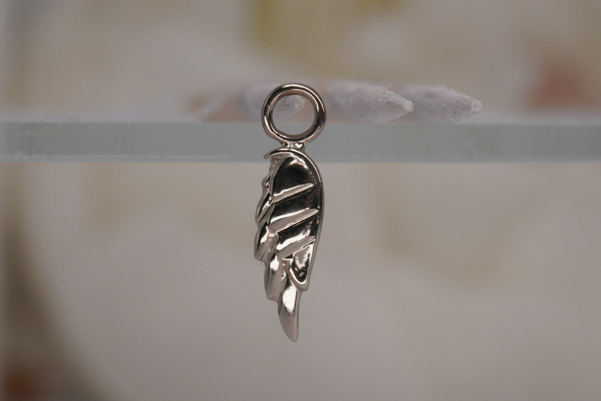 Forward Facing Norvoch 14k Angel Wing Charm in white gold piercing chain, front view