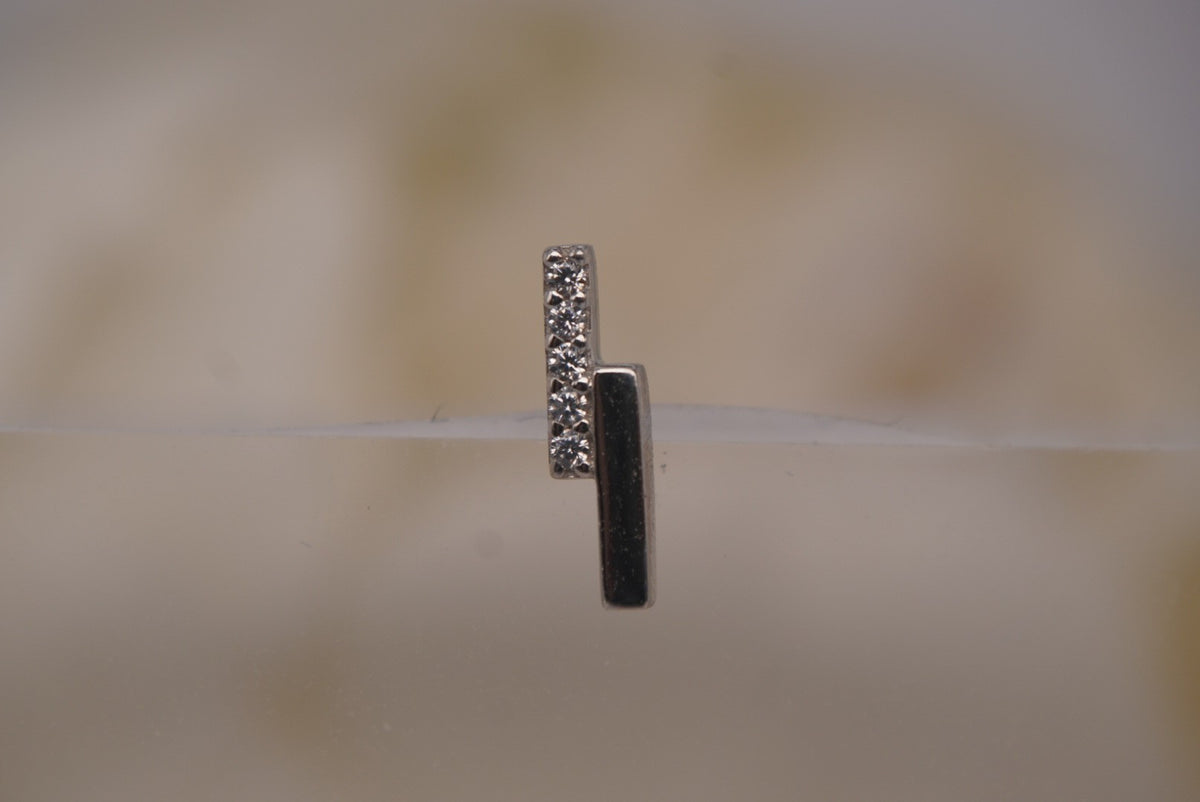 Front view of Buddha Jewelry’s “Encore” in 14k white gold, featuring a slim polished bar paired with a line of shimmering crystals.