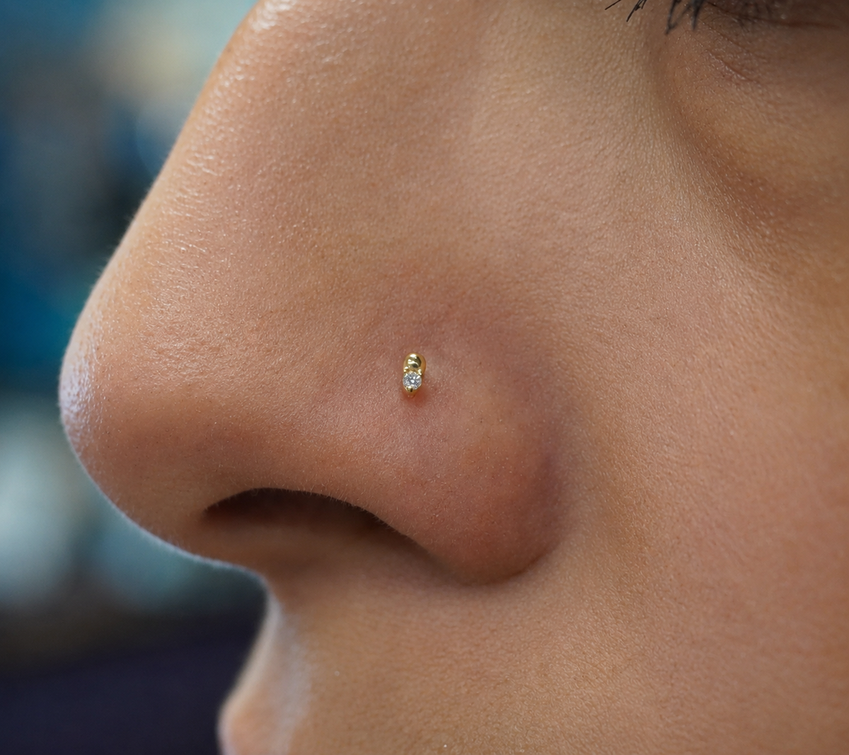 Buddha Jewelry Organics’ “Babe” crystal threadless end worn in a piercing, showing its petite size.
