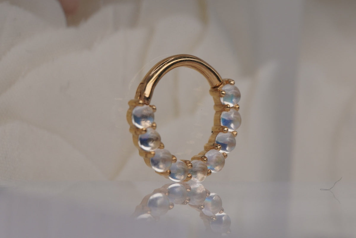 Buddha Jewelry 14k gold "Revel" clicker in 16g 5/16" with Rainbow Moonstones in yellow gold angled