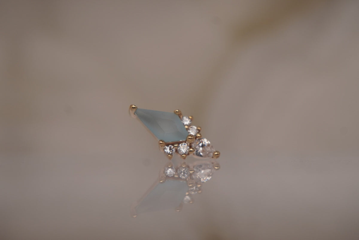 Front view of the 14k yellow gold Afterglow threadless end with sandblasted Swiss blue topaz.