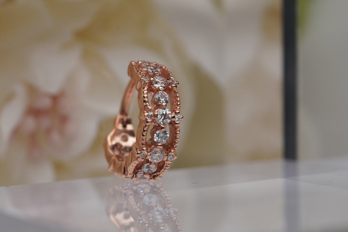 Photo of "Chaaya" Clicker in 16g 3/8" Rose Gold with White Crystals, front angled view