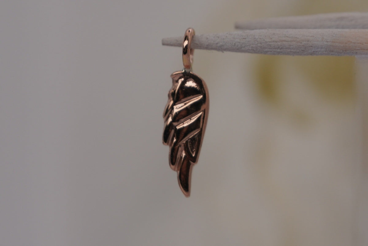 Side Facing Norvoch 14k Angel Wing Charm pendant in Yellow gold piercing charm, front view