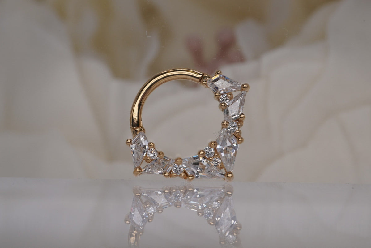 Front view of Buddha Jewelry’s “Legacy” clicker in 14k yellow gold, featuring an ornate arc of faceted crystals in layered shapes.