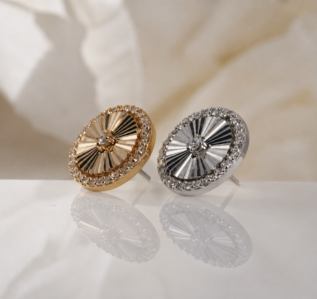 Angled view of the yellow and white gold Ascend ends, showing their textured surfaces.