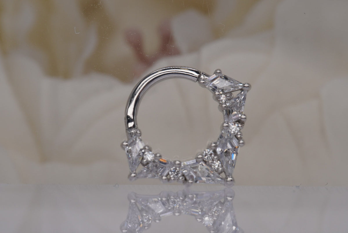 Front view of Buddha Jewelry’s “Legacy” clicker in 14k white gold, featuring an ornate arc of faceted crystals in layered shapes.
