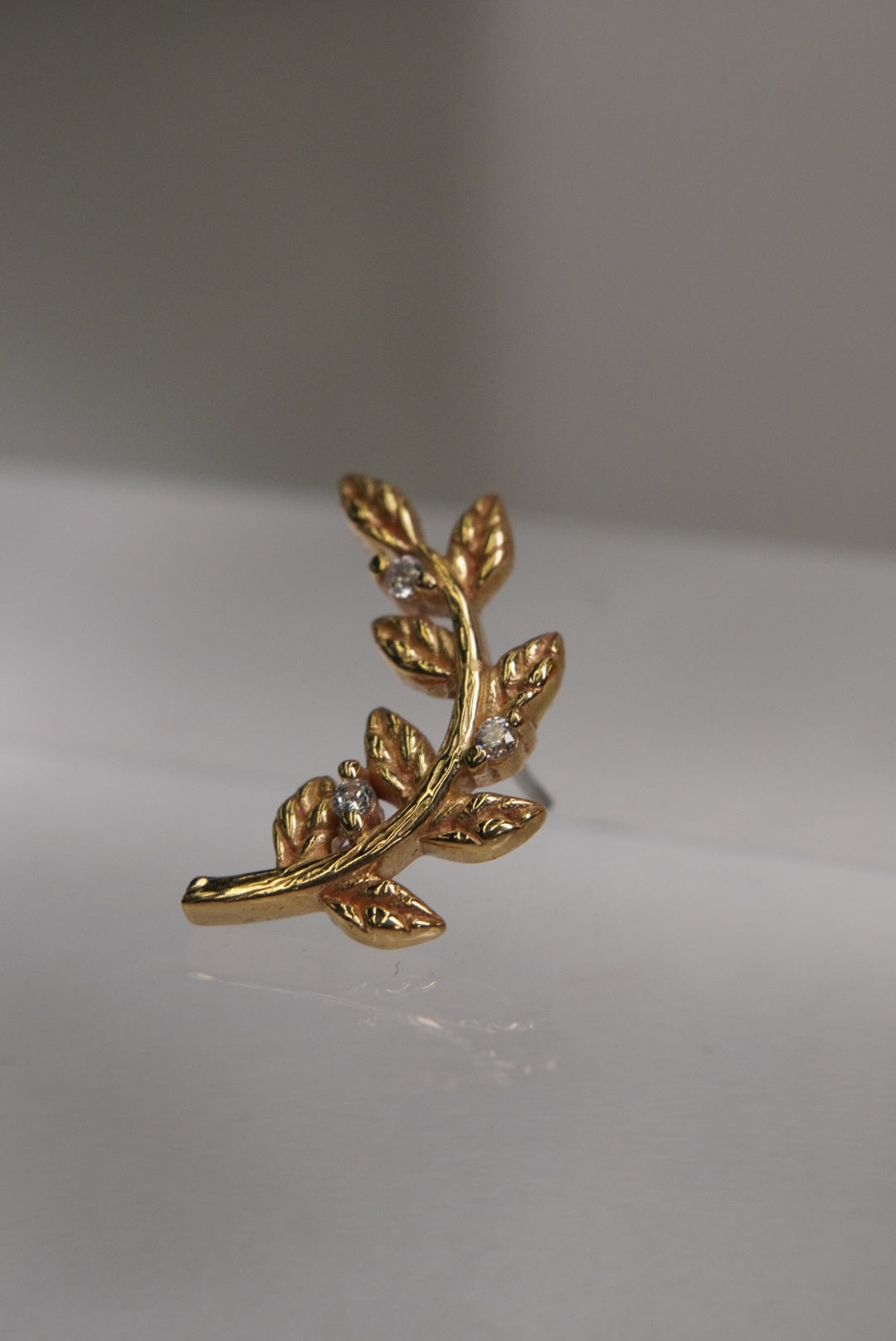 Side view of the Branch design, showing its gold profile.