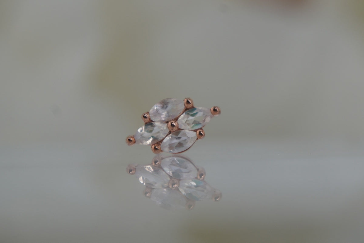 Front view of Buddha Jewelry’s “Dream On” in 14k rose gold, featuring marquise-shaped rainbow moonstones in a softly elongated cluster.