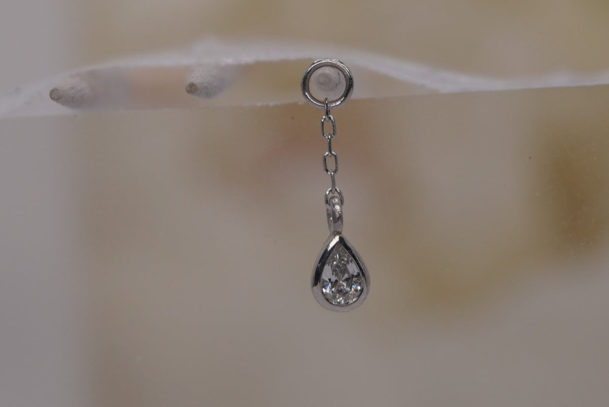 Front view of Buddha Jewelry’s “Concorde Chain” in 14k white gold, featuring a fine chain leading to a faceted white topaz drop.