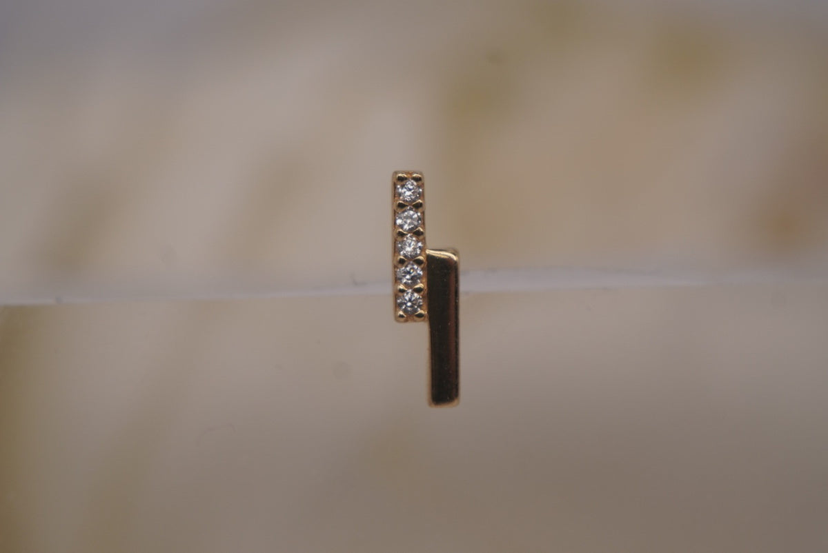 Front view of Buddha Jewelry’s “Encore” in 14k yellow gold, featuring a slim polished bar paired with a line of shimmering crystals.