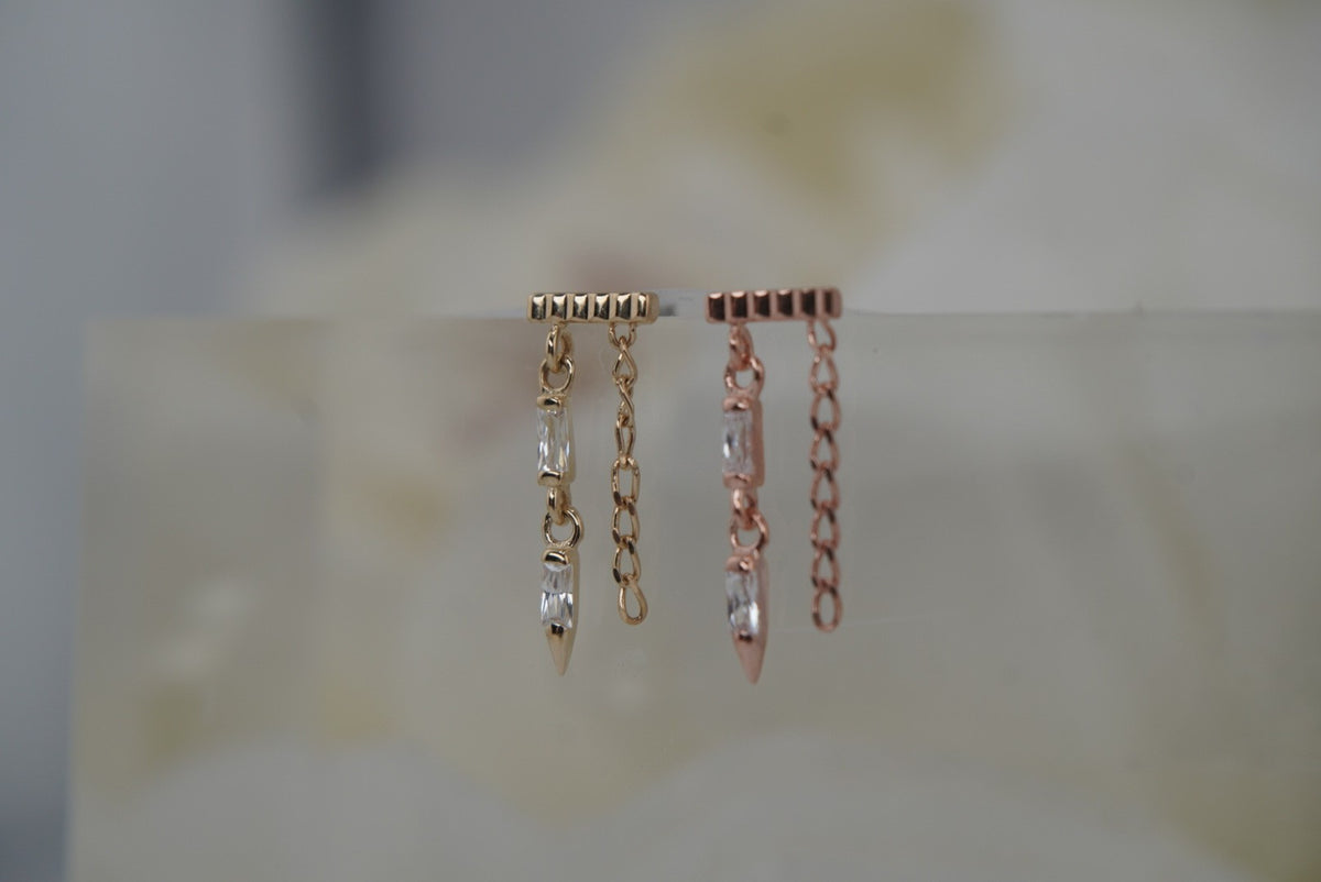 Angled view of Buddha Jewelry’s “Double Vision” in 14k yellow and rose gold, highlighting the ribbed texture, sparkling crystals, and dimensional chain details.
