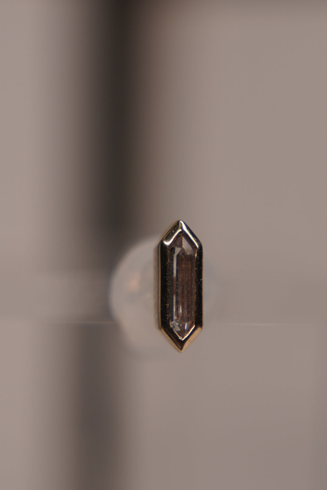 Side view of the baguette crystal design, showing its slim gold profile.